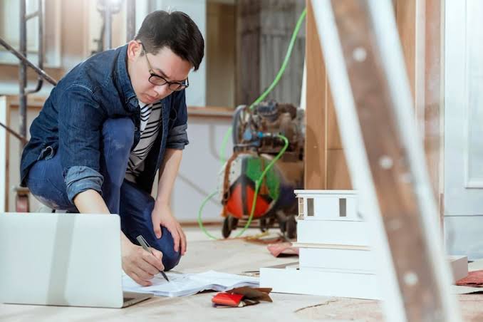 professional general contractors reviewing structural blueprints before construction. Home Renovation Contractors Near Me